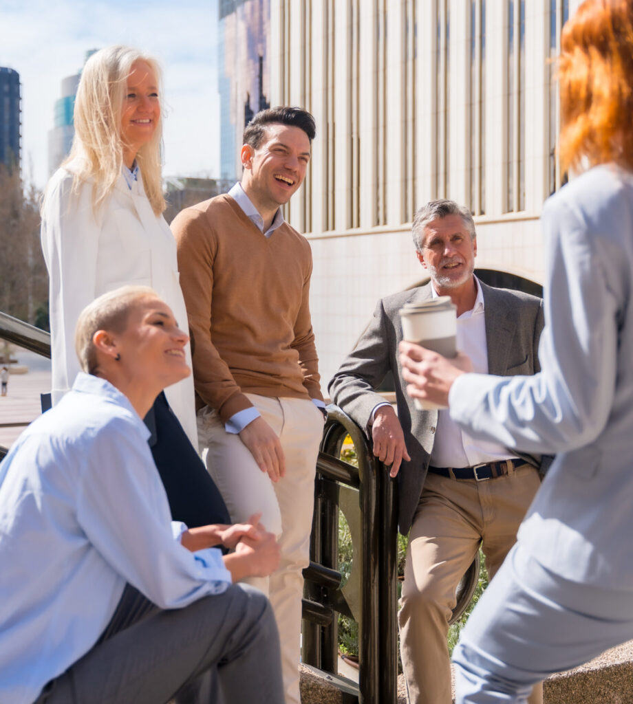 Cheerful Group Coworkers Outdoors Corporate Office Area Resting Laughing Sunny Morning Scaled E1776849891180 920x1024