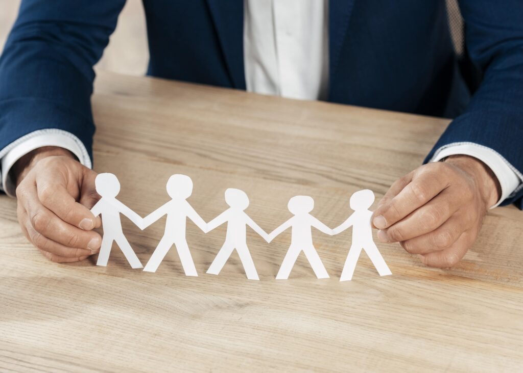 Close Up Hands Holding Paper People 1024x732